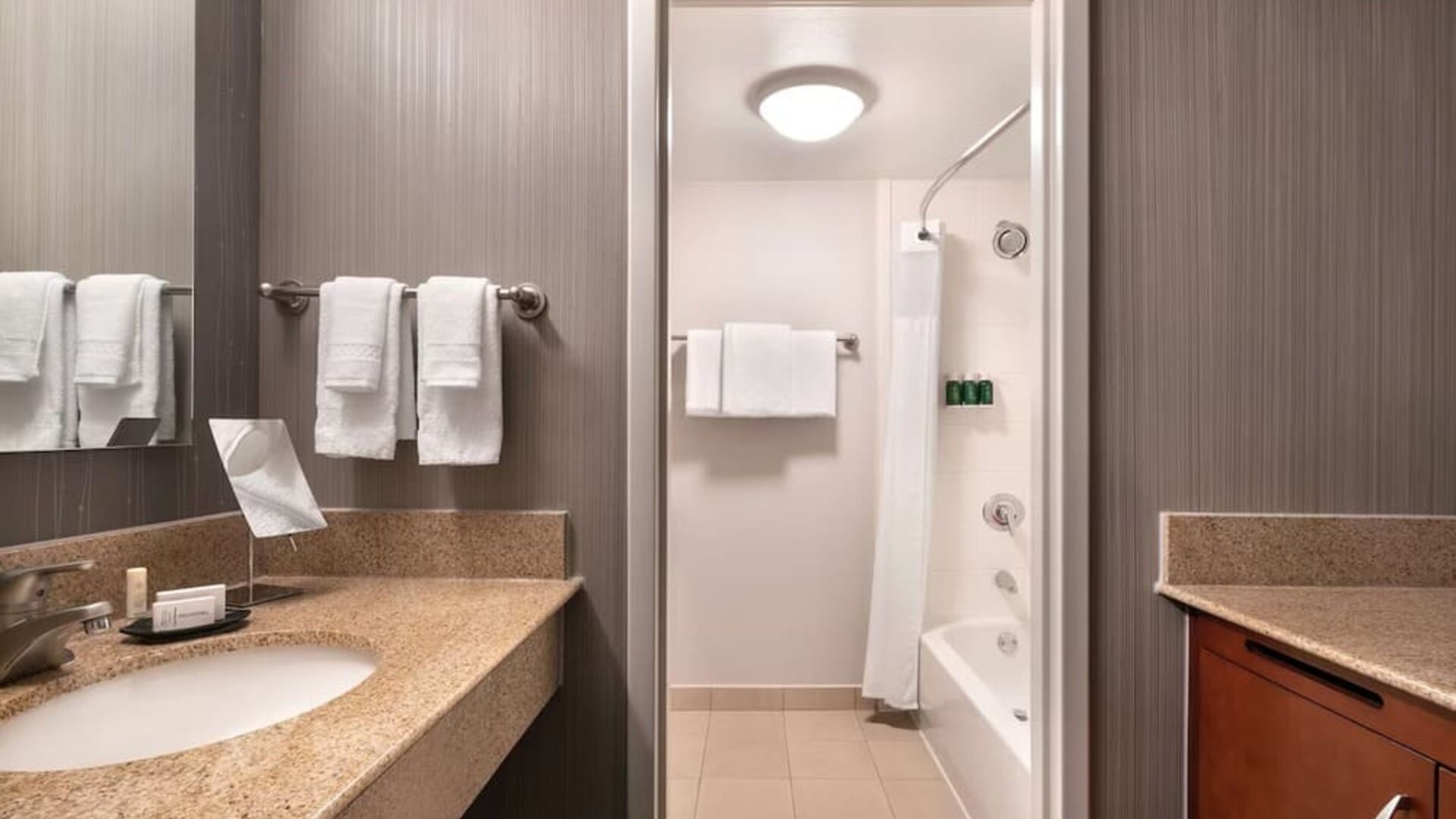 Private guest bathroom with combined shower and tub at Sonesta Select Phoenix Camelback.
