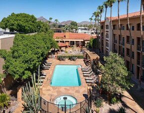 Outdoor pool with lounge seating at Sonesta Select Phoenix Camelback.