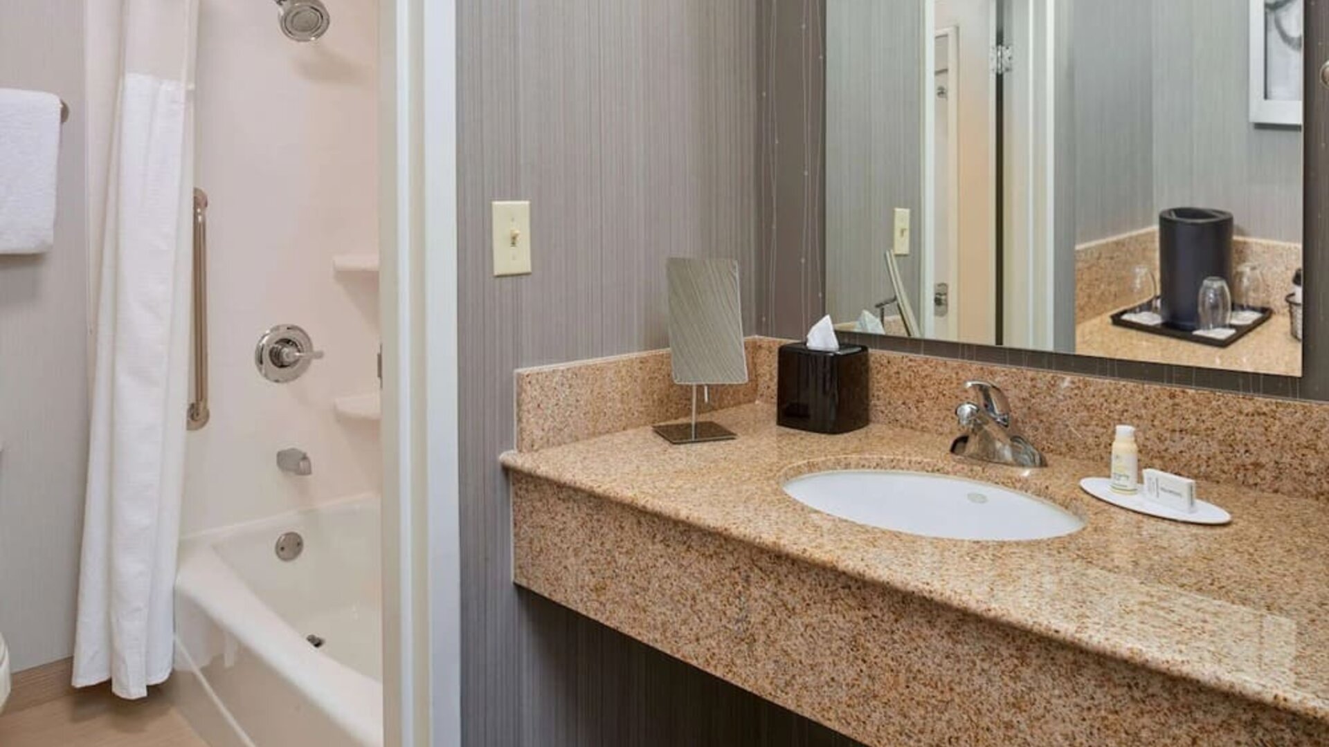 Private guest bathroom with shower and free toiletries at Sonesta Select Indianapolis Carmel.