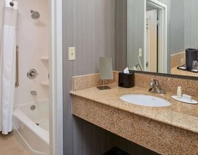 Private guest bathroom with shower and free toiletries at Sonesta Select Indianapolis Carmel.