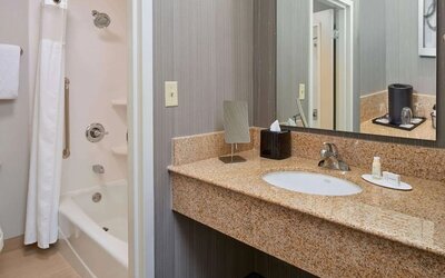 Private guest bathroom with shower and free toiletries at Sonesta Select Indianapolis Carmel.
