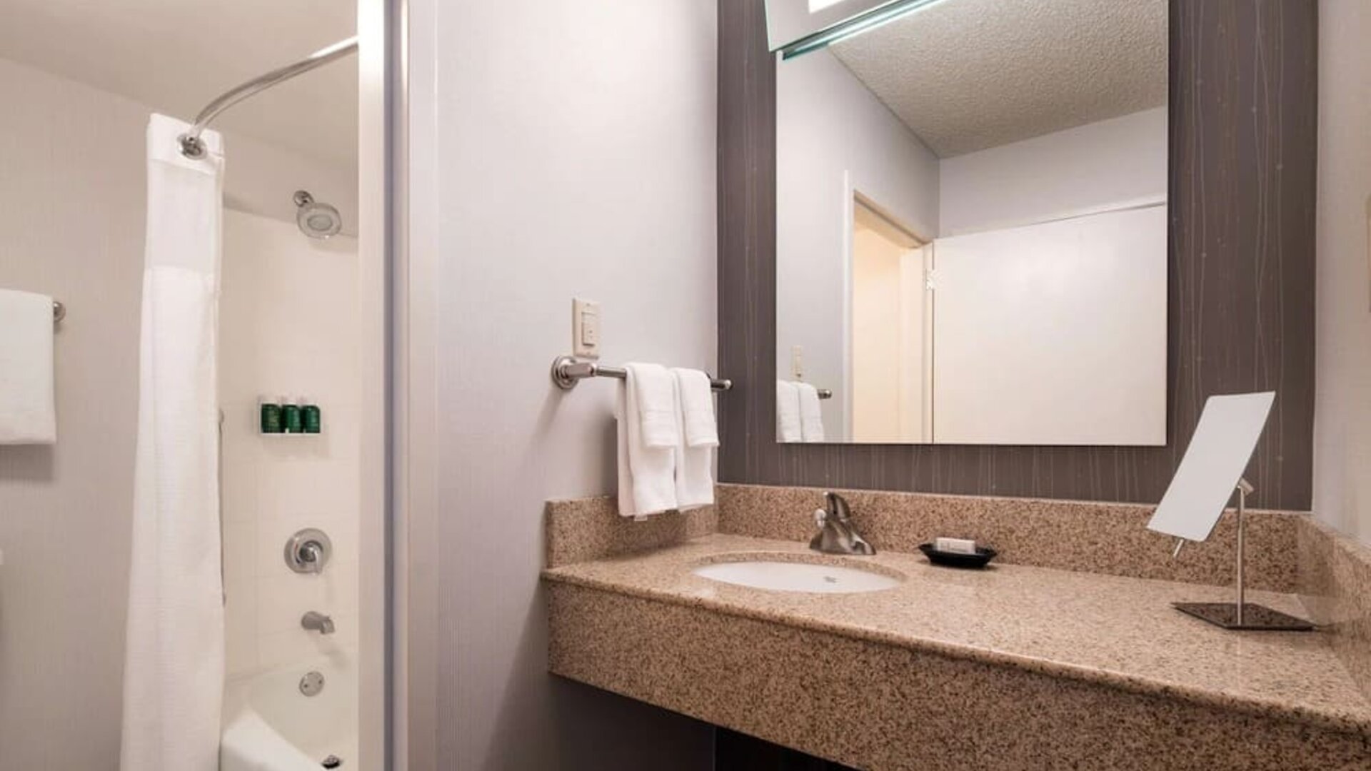 Private guest bathroom with shower and free toiletries at Sonesta Select Los Angeles LAX El Segundo.