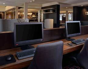 Business center with computers, printer and ergonomic chair at Sonesta Select Kansas City South Overland Park.