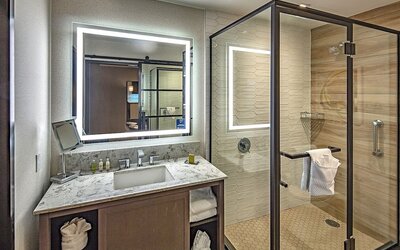 Guest bathroom with shower at DoubleTree By Hilton Modesto.