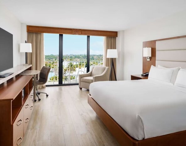 King size bed, work desk and balcony at DoubleTree Beach Resort By Hilton Tampa Bay - North Redington.
