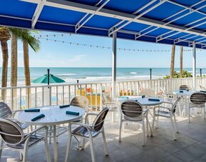 Alfresco dining with a view of the beach at DoubleTree Beach Resort By Hilton Tampa Bay - North Redington.
