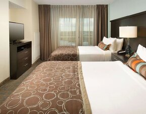 Day use twin room with floor to ceiling window at Sonesta ES Suites Dallas Las Colinas.