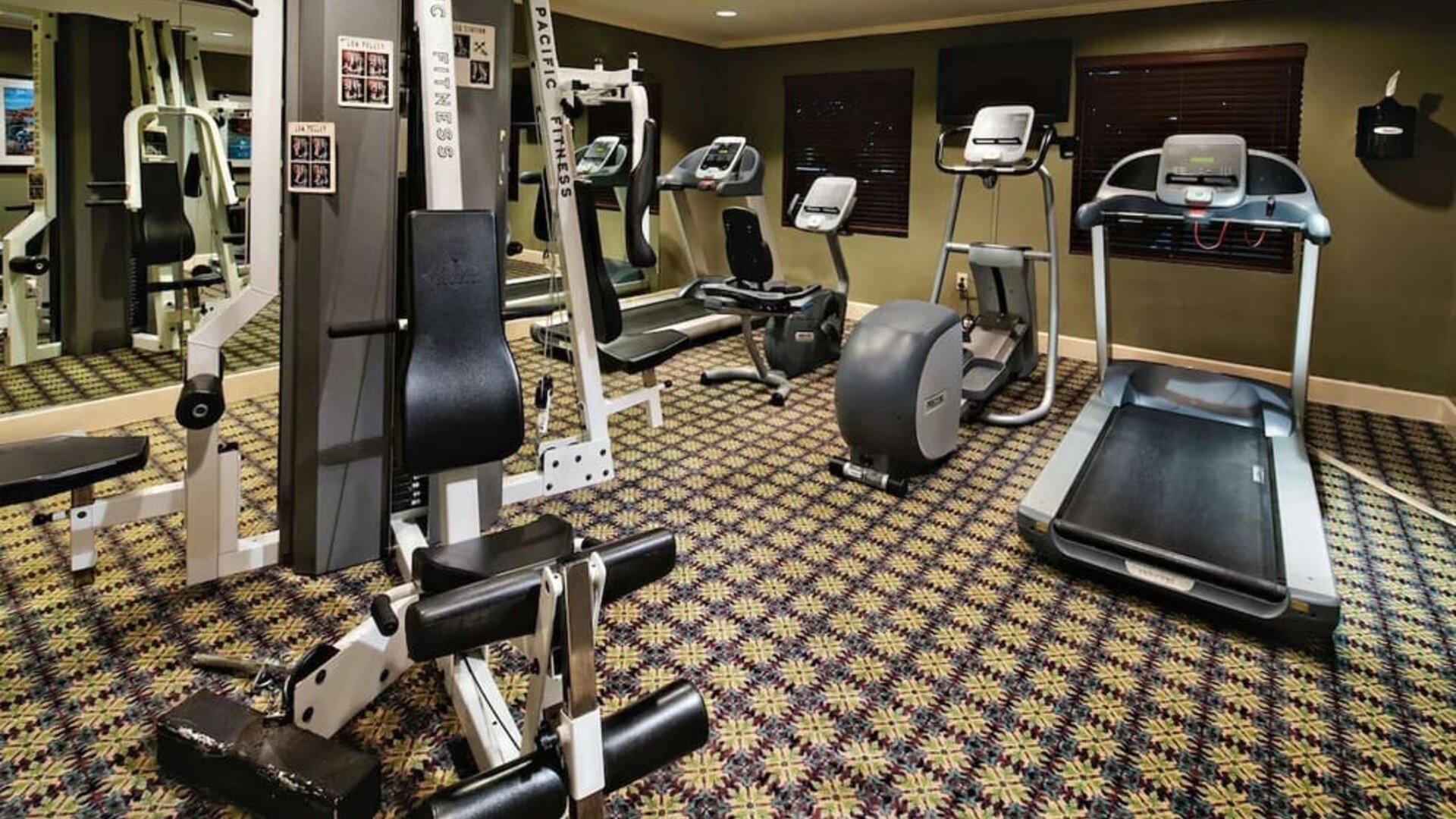 Sonesta ES Suites Dallas Las Colinas’ fitness center has a wall-mounted television and assorted exercise machines for guests to use.