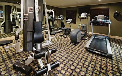 Sonesta ES Suites Dallas Las Colinas’ fitness center has a wall-mounted television and assorted exercise machines for guests to use.