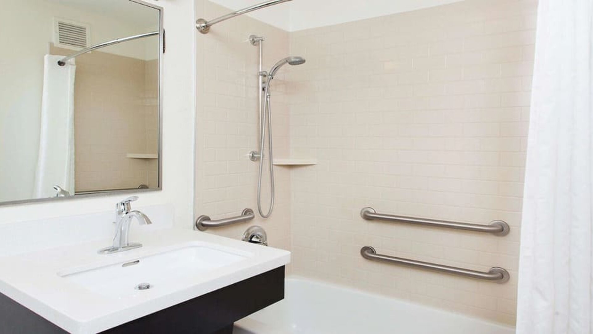 Private guest bathroom with shower at Sonesta Simply Suites Plano Frisco.