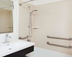 Private guest bathroom with shower at Sonesta Simply Suites Plano Frisco.