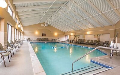 Refreshing indoor pool surrounded by loungers at DoubleTree By Hilton Grand Rapids Airport.
