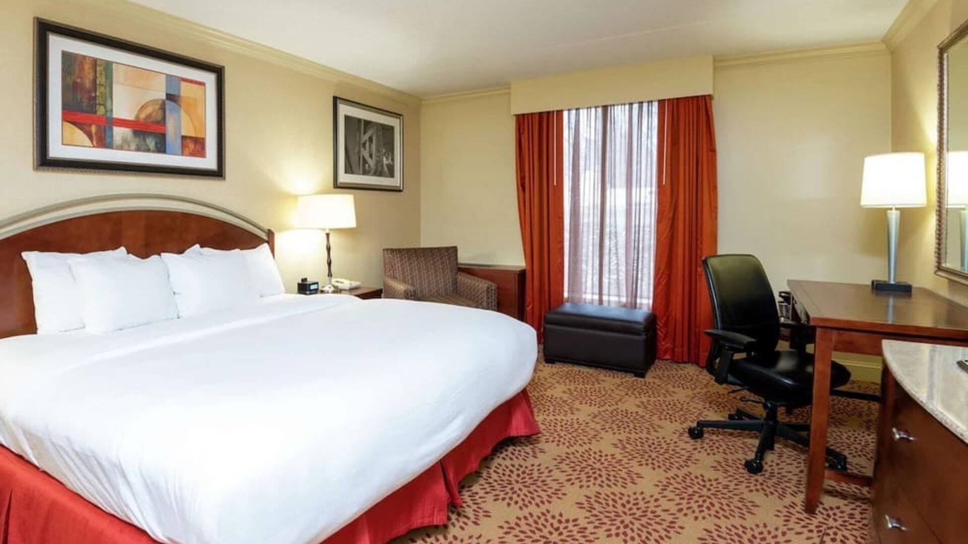 Work desk and sofa in a king bedroom at DoubleTree By Hilton Grand Rapids Airport.