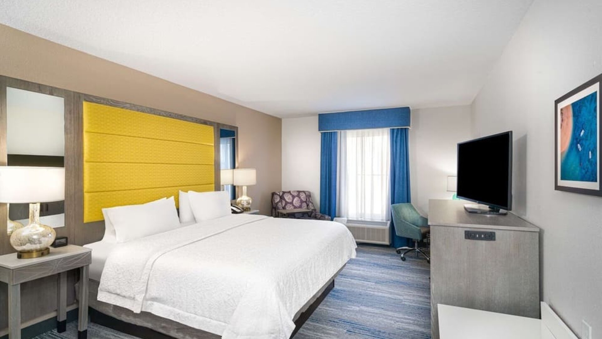 King size bed with work desk at Hampton Inn & Suites Amelia Island-Historic Harbor Front.