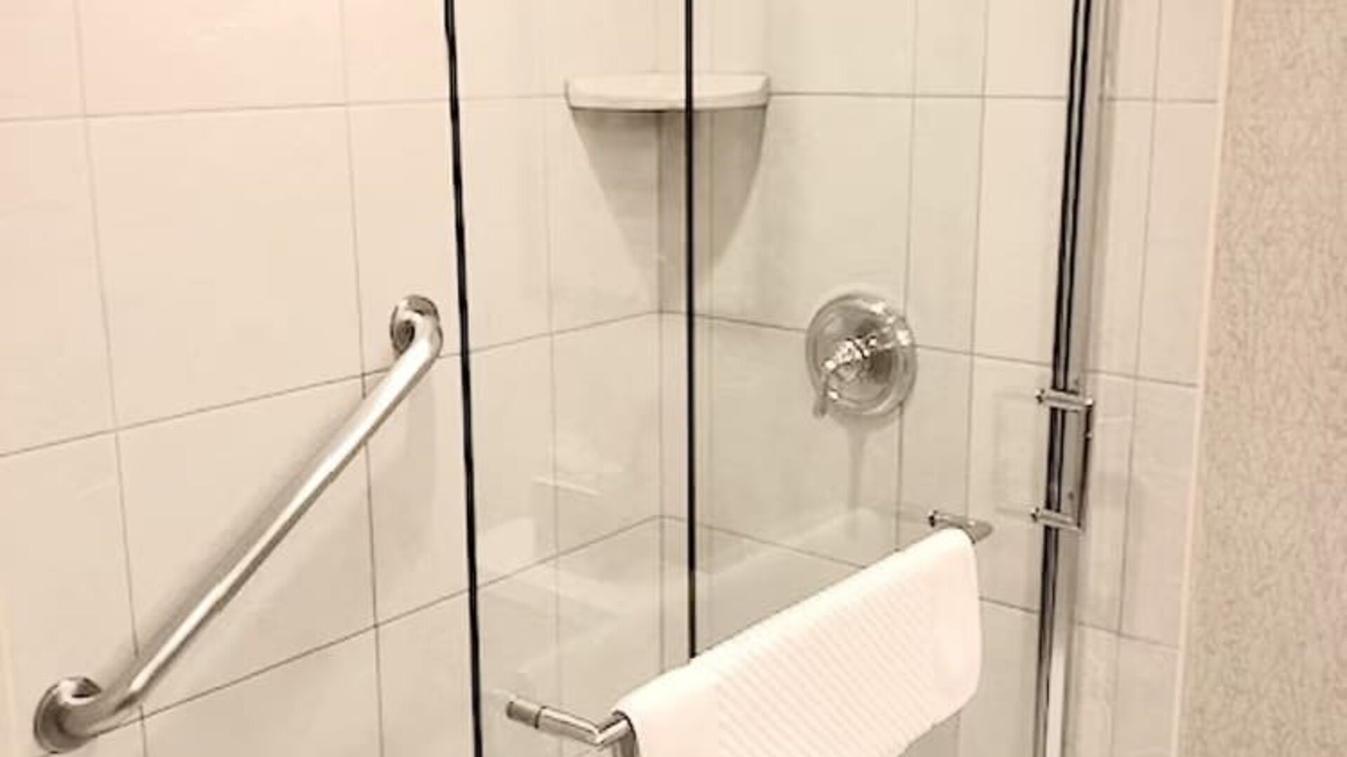 Guest bathroom with shower at DoubleTree By Hilton Lisle-Naperville.