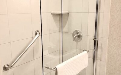 Guest bathroom with shower at DoubleTree By Hilton Lisle-Naperville.