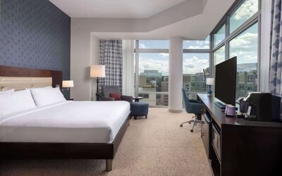 Bright king room with work station and a view of the city at Hilton Garden Inn Washington DC/Georgetown Area.
