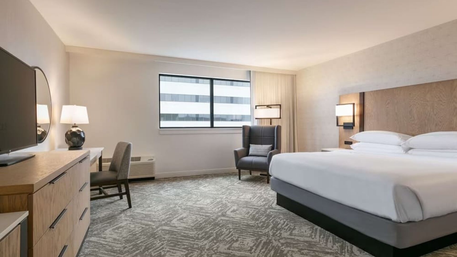 Spacious king size bed, TV and desk in a day use room at DoubleTree By Hilton Canton Downtown.