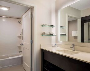 Private guest bathroom with combined shower and tub at Sonesta ES Suites Parsippany Morris Plains.