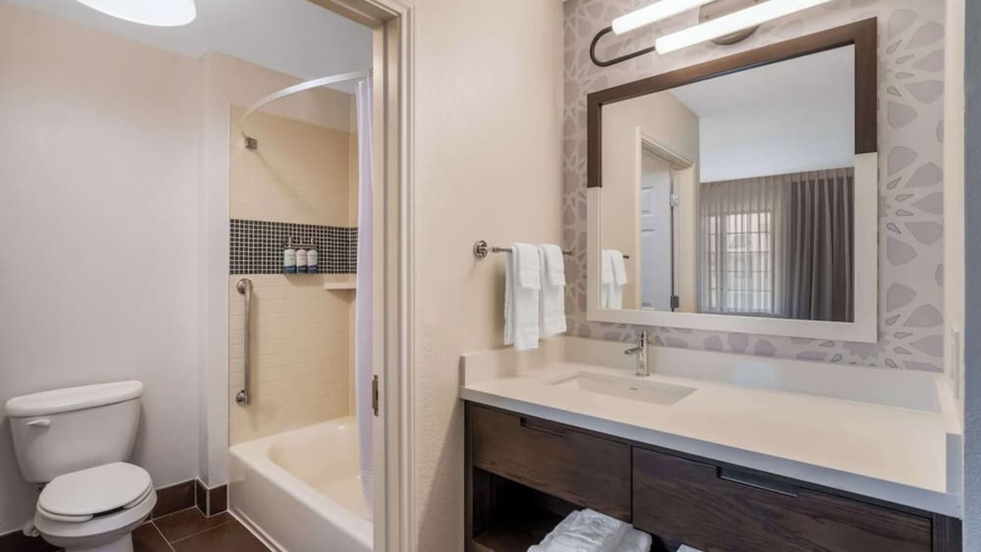 Private guest bathroom with combined shower and tub at Sonesta ES Suites Austin The Domain Area.