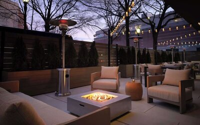 Patio with lounge seating and fire pit at Sonesta White Plains Downtown.