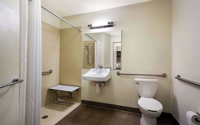 Accessible private guest bathroom with shower at Sonesta Simply Suites St Louis Earth City.