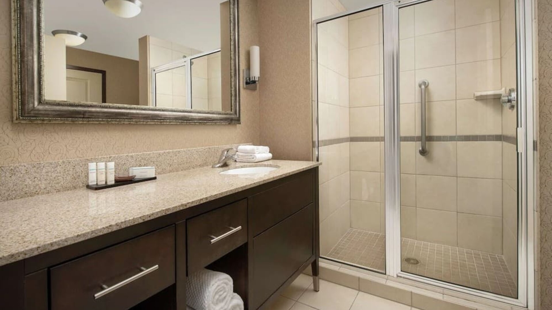 Guest bathroom with shower at Embassy Suites By Hilton Birmingham.