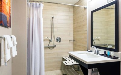 Accessible private guest bathroom with shower at Sonesta Atlanta Airport North.