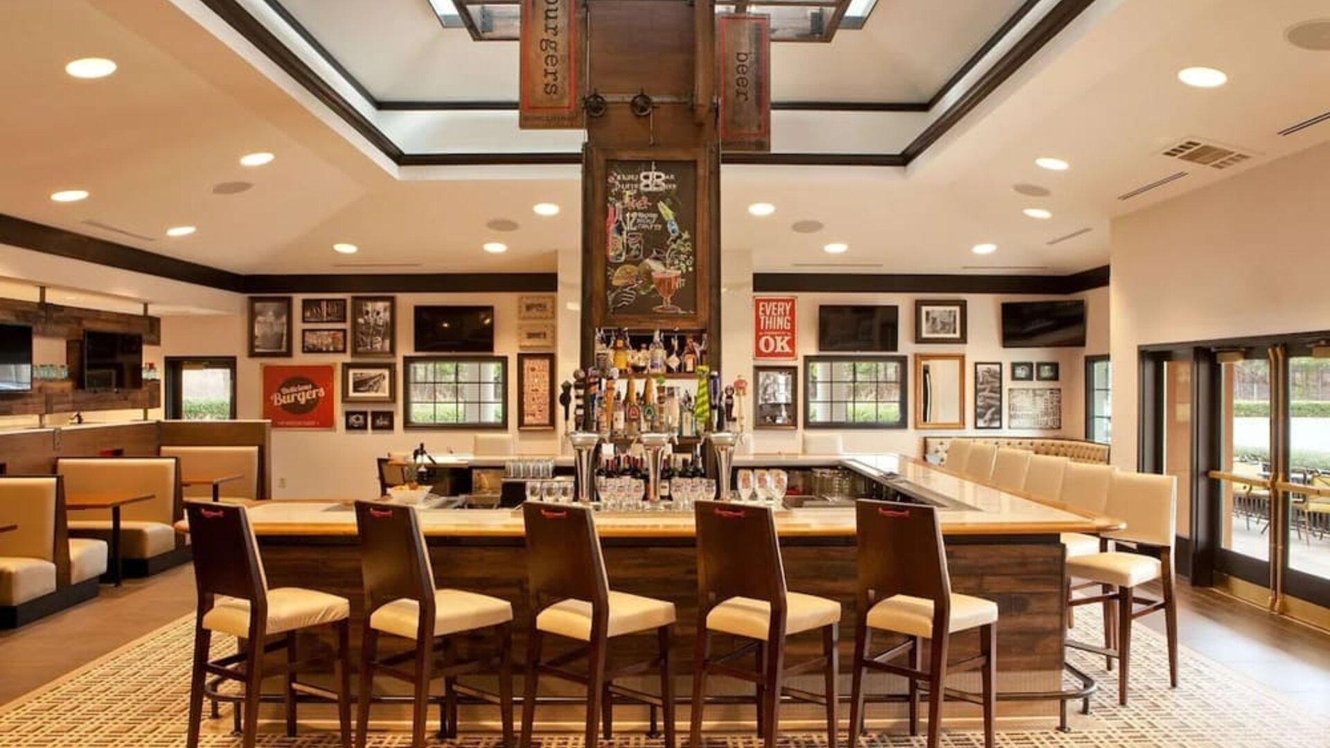 Sonesta Atlanta Airport South’s bar has numerous televisions on the wall, tall bar stools and booth seating, and a broad range of beverages.