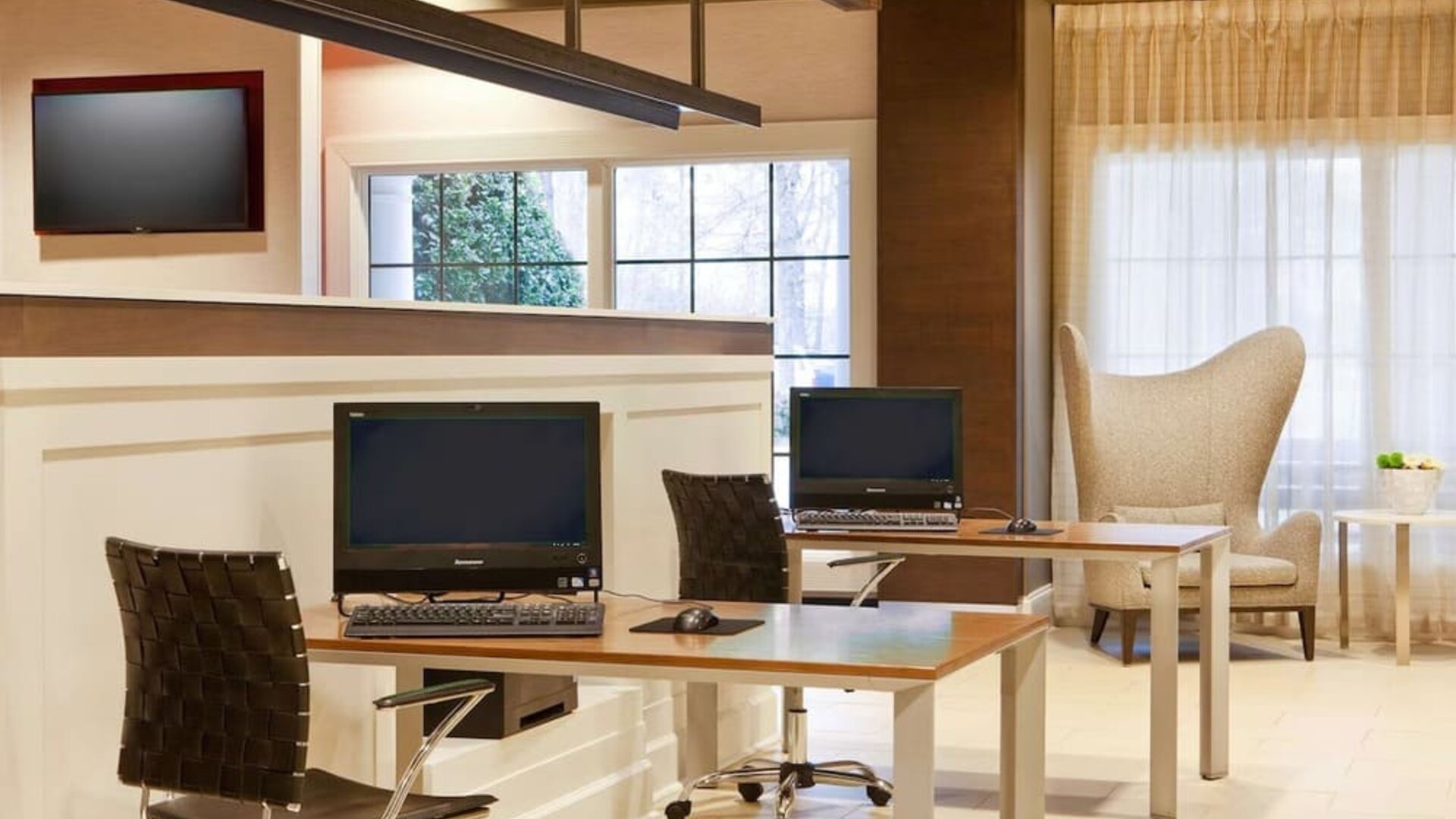 Business center with computers, printer and comfortable seating at Sonesta Atlanta Airport South.