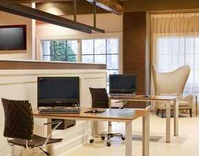 Business center with computers, printer and comfortable seating at Sonesta Atlanta Airport South.