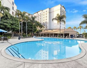 Outdoor pool with lounge area at Sonesta Anaheim Resort Area.