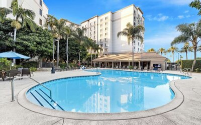 Outdoor pool with lounge area at Sonesta Anaheim Resort Area.