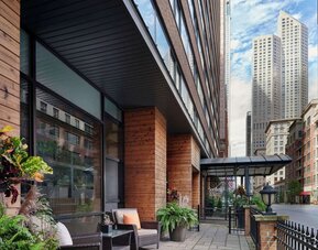 Hotel entrance and terrace with lounge seating at Sonesta ES Suites Chicago Downtown Magnificent Mile - Medical.