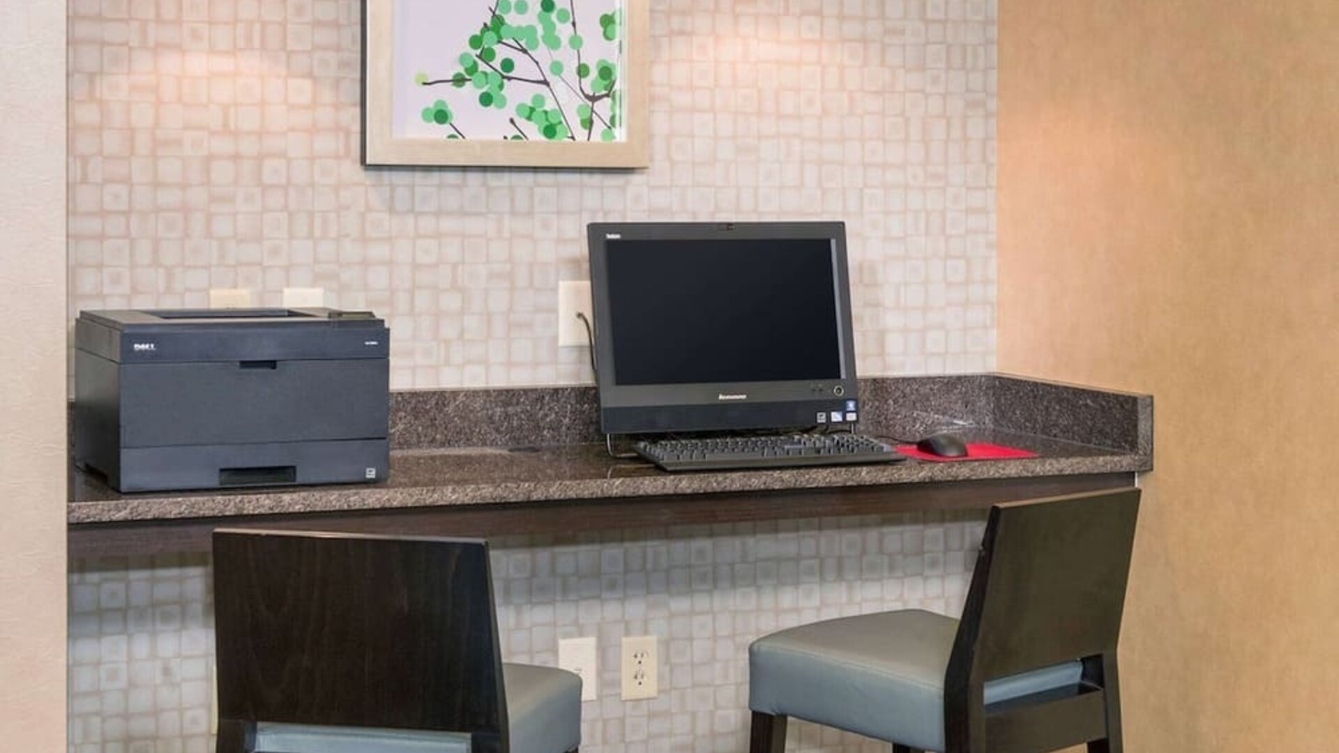 Business center with computer, printer and comfortable chairs at Sonesta ES Suites Charlottesville University.
