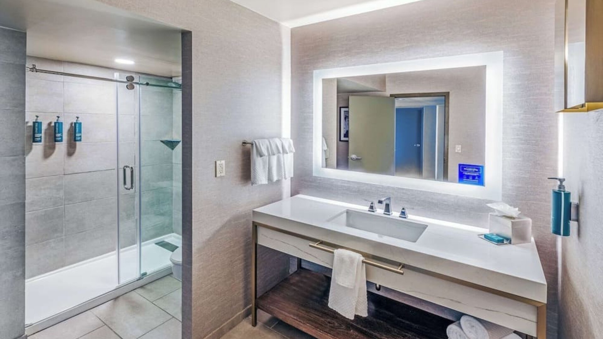 Guest bathroom with shower at DoubleTree By Hilton Tulsa-Downtown.
