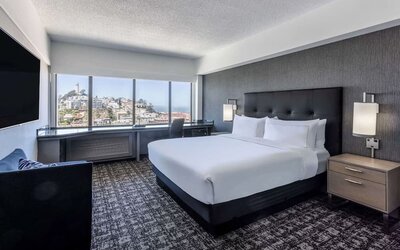 Day use room with sofa and work desk overlooking the city at Hilton San Francisco Financial District.