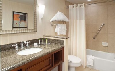 Guest bathroom with shower and tub at DoubleTree By Hilton Albuquerque.