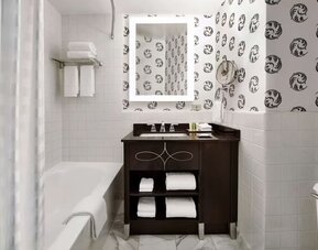 Guest bathroom with shower and tub at Palmer House A Hilton Hotel.