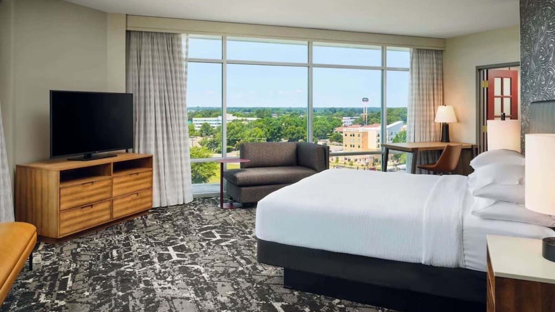 Spacious day use room with work desk overlooking the city at Embassy Suites By Hilton Hampton Convention Center.