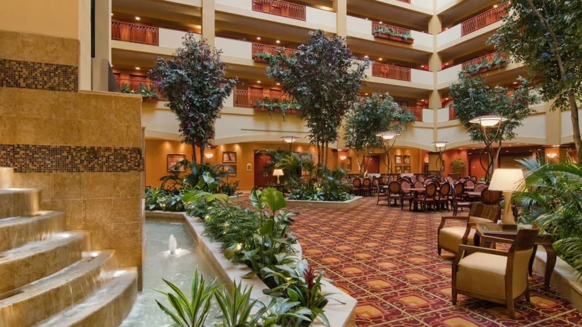 Spacious lobby and coworking lounge with natural light at Embassy Suites By Hilton Hampton Convention Center.