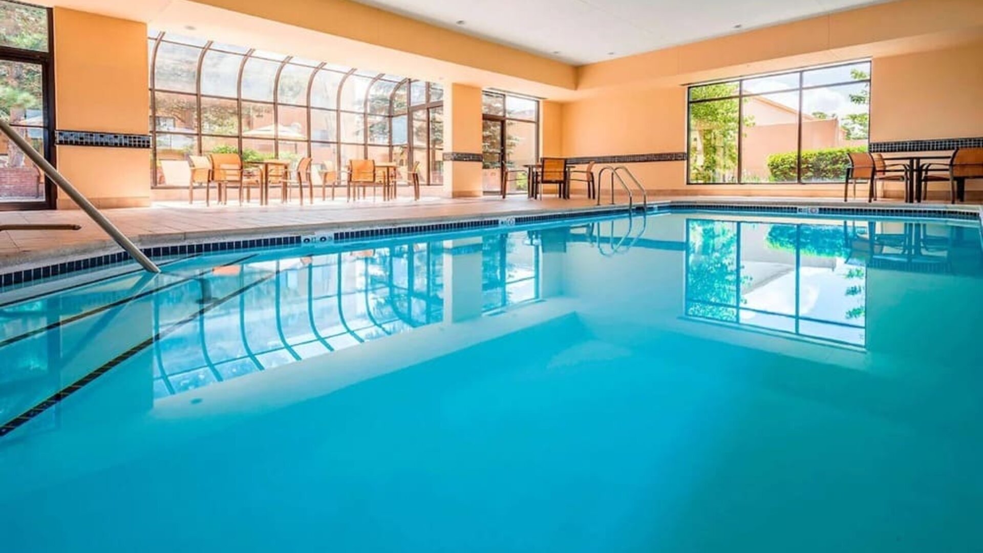 Indoor pool with lounge chairs at Sonesta Select Boston Milford.