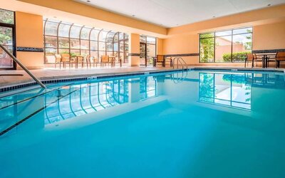 Indoor pool with lounge chairs at Sonesta Select Boston Milford.