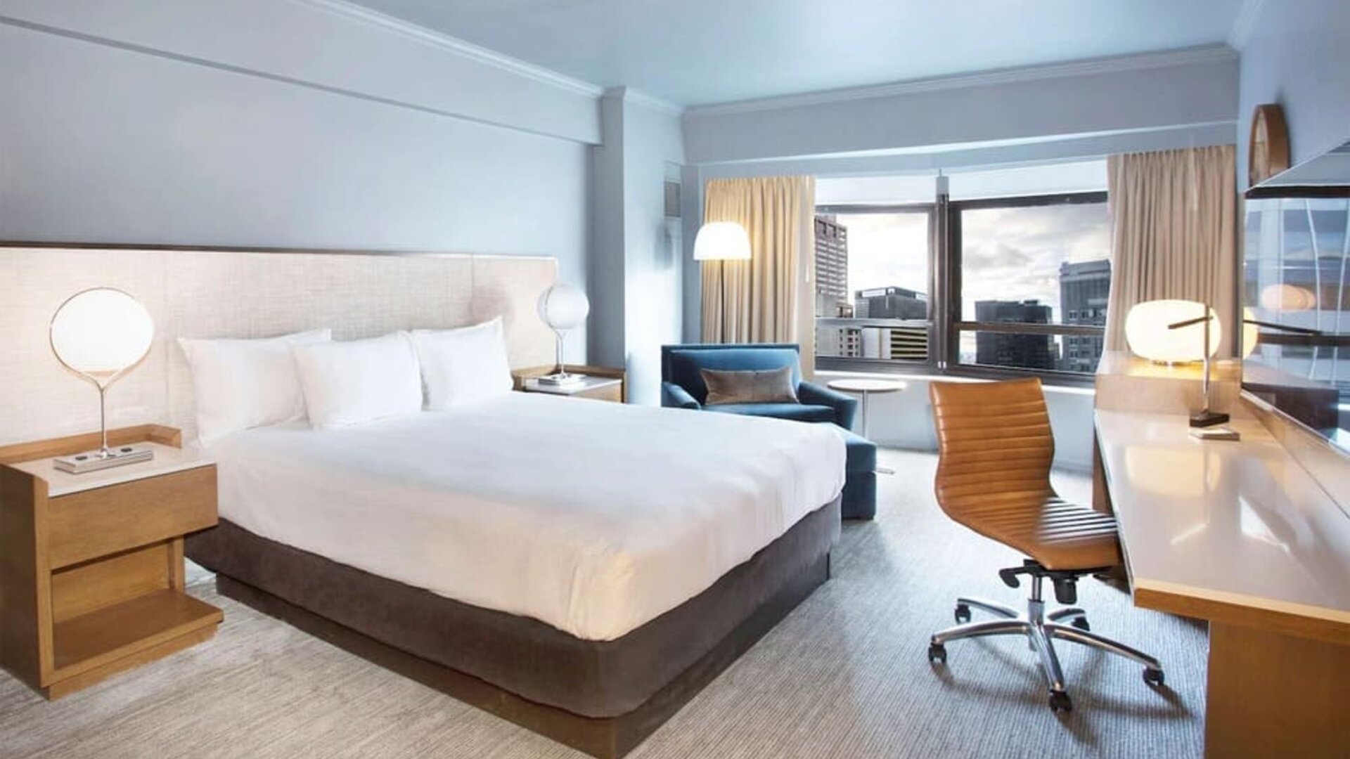 Day use room with work desk and natural light at New York Hilton Midtown.