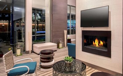 Comfortable lobby workspace by the fireplace at Hilton Garden Inn NYC Financial Center/Manhattan Downtown.
