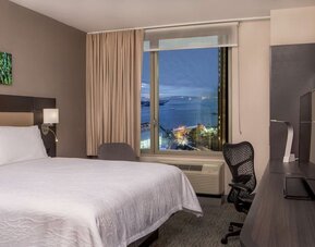 King bedroom with work station and city view at Hilton Garden Inn NYC Financial Center/Manhattan Downtown.
