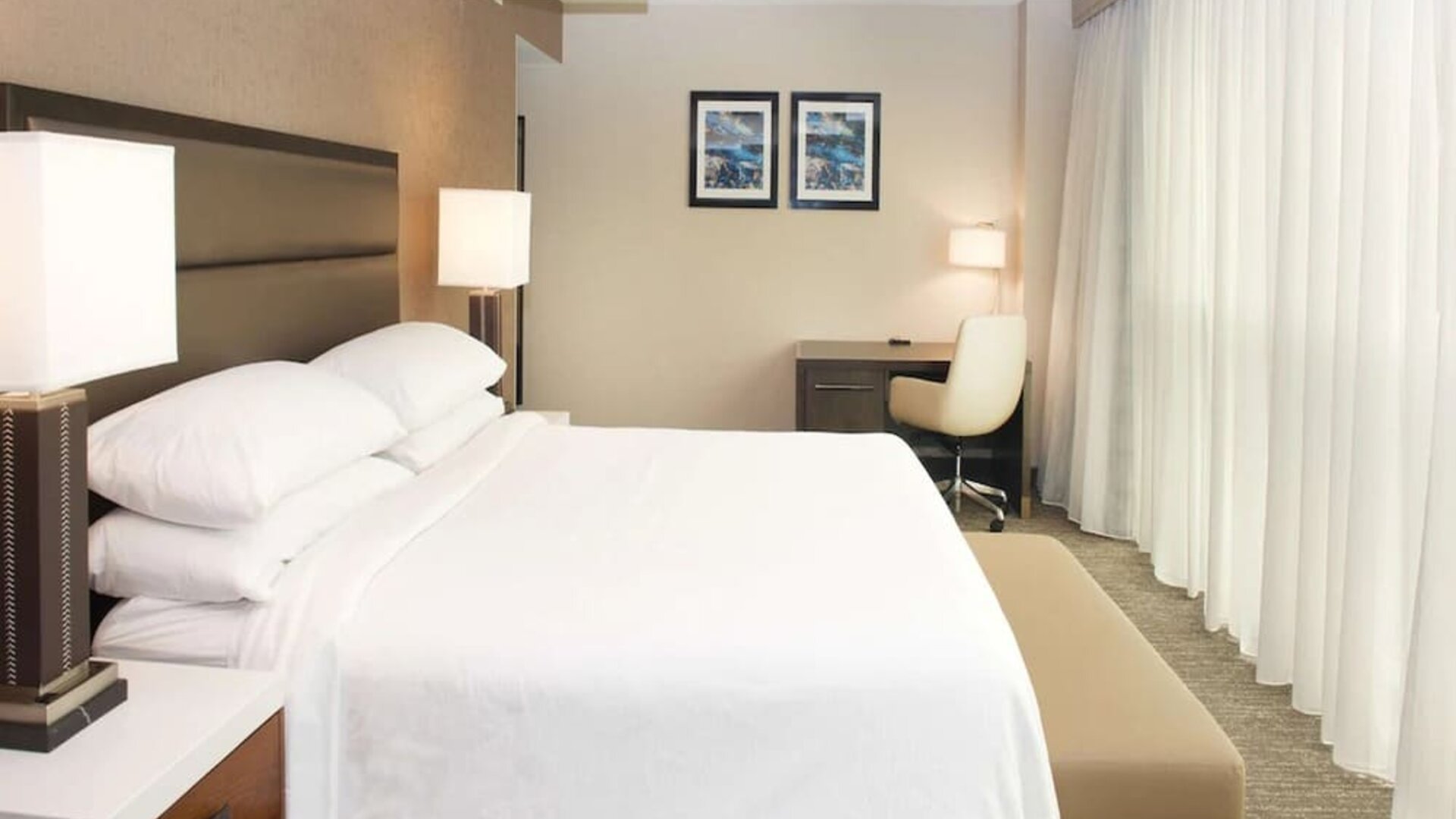 Spacious delux king room with work desk and natural light at Embassy Suites By Hilton Seattle-North-Lynnwood.