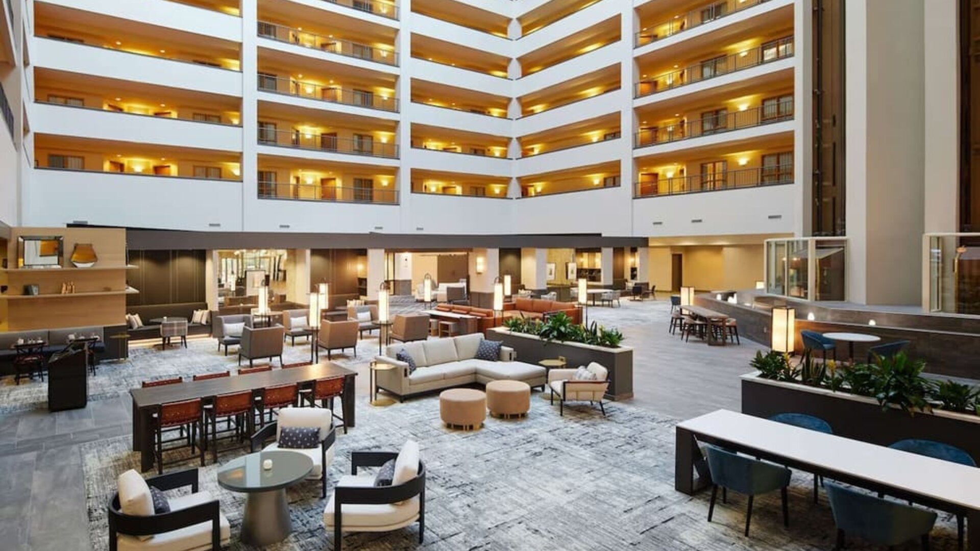Spacious lobby and coworking lounge at Hilton Charlotte Airport.

