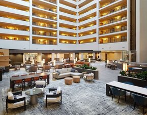 Spacious lobby and coworking lounge at Hilton Charlotte Airport.

