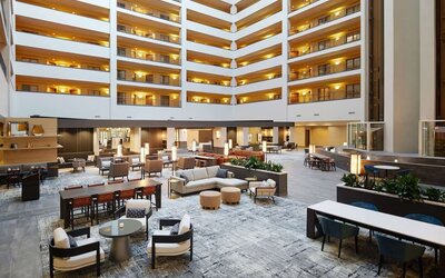 Spacious lobby and coworking lounge at Hilton Charlotte Airport.
